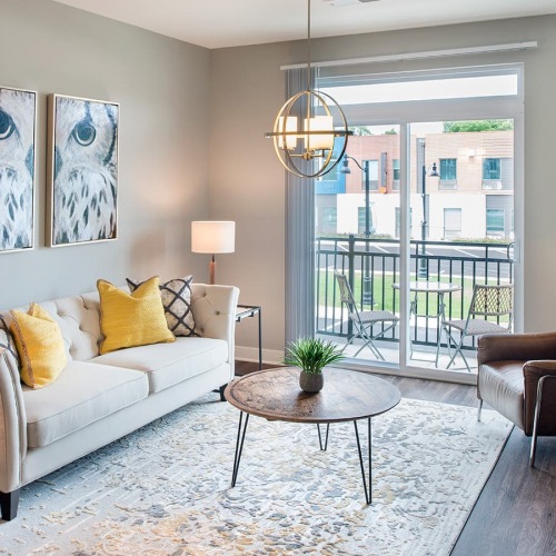 Living Space living area with large open spaces and lots of natural lighting through tall windows