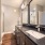 double vanity with wood-style flooring and spacious counterspace