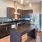 kitchen area on wooden floor with spacious counter-space and designer appliances